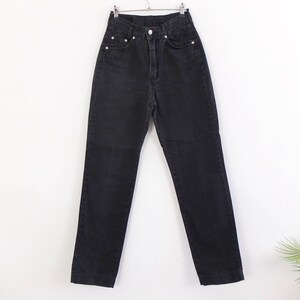 May include: Black high-waisted jeans with a straight leg fit.