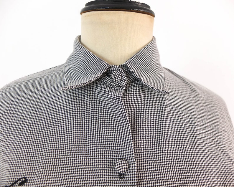 May include: A white and black gingham button-down shirt with a pointed collar.