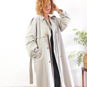 The trench coat is size Large or XL, depends on how loose you like it!. The chest contour fit is 51,1 inches (130 cm)