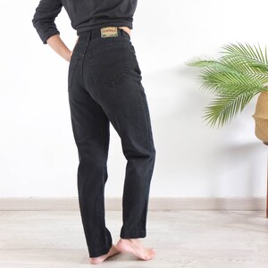 The vintage black denim jeans is Cotton fabric in excellent vintage conditions by New Horses.