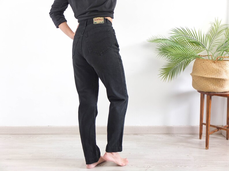 The vintage black denim jeans is Cotton fabric in excellent vintage conditions by New Horses.