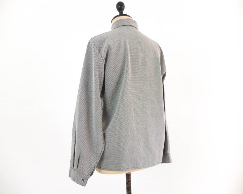 May include: A gray long-sleeved button-up shirt with a subtle pattern.