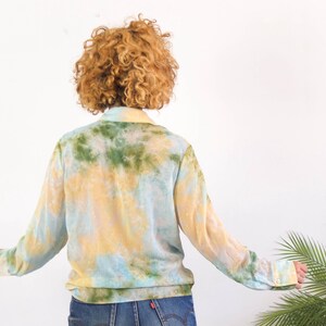 The vintage indie retro hipster bleached blouse is made of sheer polyester fabric in excellent vintage condition (Made in Spain), also retains an additional button.