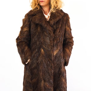 The fur coat is size Medium or Large, depends on how loose you like it!. The chest contour fit is 39,3 inches (100 cm)