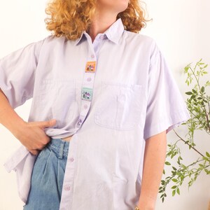The retro shirt is size Medium - Large, the chest contour fit is 48 inches (122 cm), it depends on how loose you like it!
