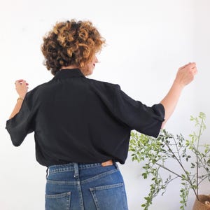 The vintage retro basic black button up shirt is polyester fabric in excellent vintage condition (made in Europe).