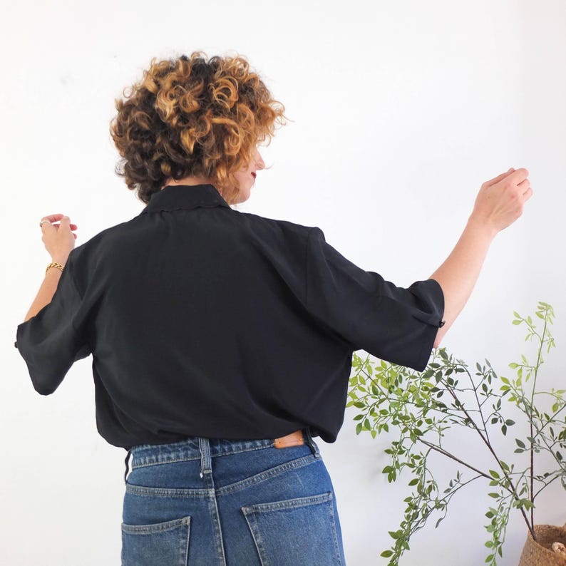 The vintage retro basic black button up shirt is polyester fabric in excellent vintage condition (made in Europe).