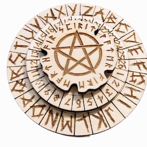 May include: A wooden, layered puzzle featuring a pentagram at its core. The puzzle comprises three circular layers, each adorned with etched symbols and letters. The design, in shades of brown, is set against a white backdrop. The puzzle's design hints at a mystical or esoteric theme.