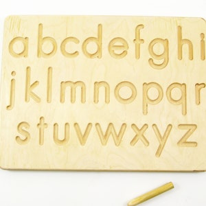 Peut inclure: Planche de tra&ccedil;age en bois avec l'alphabet en minuscules de a &agrave; z grav&eacute; sur la surface. Un stylet en bois est inclus.