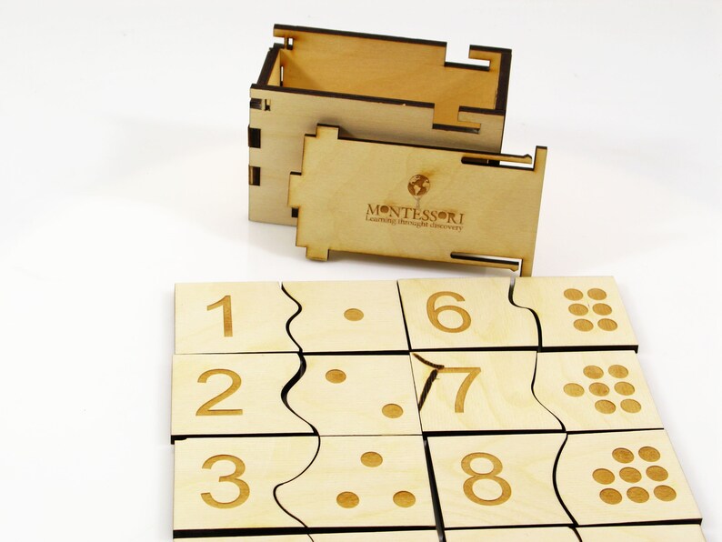 May include: Wooden Montessori puzzle with numbers 1 through 8, corresponding dots, and a wooden box with the text "MONTESSORI Learning through discovery".