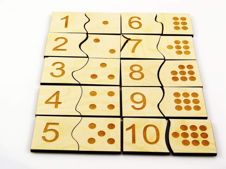 May include: Wooden puzzle with ten pieces, each piece has a number from 1 to 10 and corresponding dots. The puzzle pieces are arranged in a grid pattern.