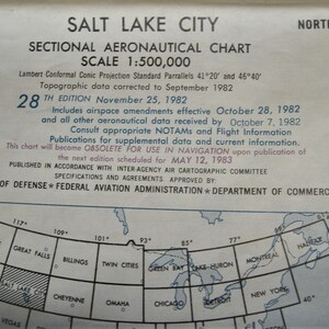May include: A black and white map of the United States with the text "Salt Lake City Sectional Aeronautical Chart Scale 1:500,000" at the top. The map shows the states of Washington, Oregon, Idaho, Montana, Wyoming, Colorado, Nebraska, Kansas, Iowa, Missouri, Illinois, Indiana, Michigan, Wisconsin, Minnesota, North Dakota, South Dakota, and parts of Canada. The map also shows the cities of Seattle, Great Falls, Billings, Twin Cities, Green Bay, Lake Huron, Montreal, and Halifax.