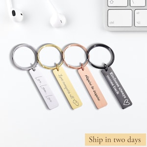 May include: Four silver keyrings with different engraved messages: "Live, Learn, Love", "Love conquers all", "Aspire to inspire", and "Kindness always comes back".