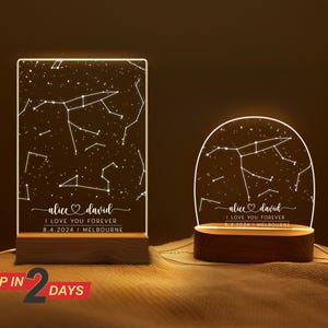 May include: Two illuminated constellation night lights with a wooden base. The lights feature a constellation design with the names "alice david" and the text "I love you forever" and the date "8.4.2024" and the location "MELBOURNE".