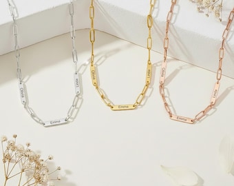 May include: Three personalized necklaces in silver, gold, and rose gold. Each necklace features a chain link design with a rectangular pendant engraved with a name. The names "Emma", "Linda", and "Olivia" are visible.