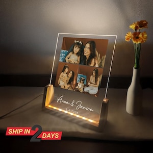 May include: A wooden photo frame with a clear acrylic panel displaying four photos of a mother and daughter. The frame has a built-in LED light strip that illuminates the photos. The frame is personalised with the text "Anna & Janice 8.4.2025".