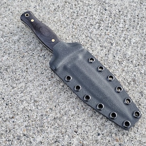 May include: A black leather knife sheath with multiple brass eyelets. The sheath is designed to hold a knife with a wooden handle.