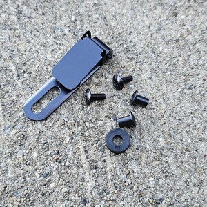 May include: A black metal clip with a black plastic cover and five black screws.