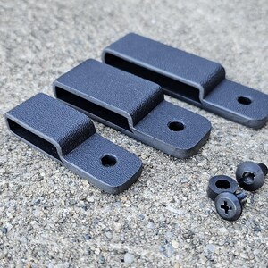 May include: Three black plastic belt clips with two black screws.