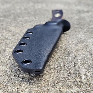 May include: Black leather knife sheath with multiple holes for belt attachment.