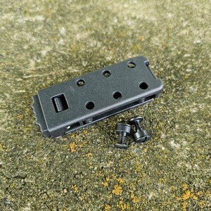 May include: Black plastic clip with a textured surface and multiple holes. Two black screws are included.