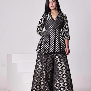May include: A black and gold brocade top with a peplum waist and three-quarter sleeves paired with matching palazzo pants.
