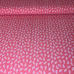 May include: Red fabric with a white leaf pattern. The leaves are small and evenly spaced.