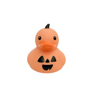 May include: A Halloween-themed rubber ducky in orange with a carved pumpkin face. The duck has a black stem, black eyes, and a bright orange beak. The pumpkin face features triangular eyes and a smiling mouth.