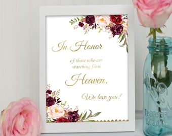 May include: White framed sign with a floral design and gold lettering. The sign reads "In Honor of those who are watching from Heaven. We love you!"