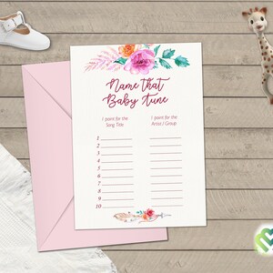 May include: A printable baby shower game card with a floral design. The card has a title that says "Name that Baby Tune". The card has two columns, one for the song title and one for the artist or group.