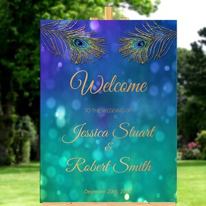 May include: A teal and purple wedding welcome sign with gold glitter peacock feathers and the text "Welcome to the wedding of Jessica Stuart & Robert Smith December 20th, 2018"