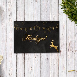 May include: A black card with gold glitter and a gold reindeer silhouette. The card says "Thank you!" in gold script.