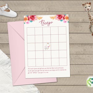 May include: A printable bingo card with a floral design and the word "Bingo" in a pink script font. The card has a 5x5 grid with blank squares. The text below the grid reads "Fill in each square with gift item you think the Mom-to-be will receive. As she opens each gift mark the name on your bingo card if it matches the gift. Get "BINGO" if you get 5 in a row."
