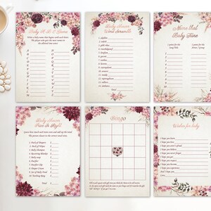 May include: A set of printable baby shower game cards with a floral design featuring pink and burgundy flowers. The games include Baby A-B-C Game, Word Scramble, Name That Baby Tune, Price It Right, Bingo, and Wishes for Baby.