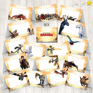 May include: A collection of folded cards featuring various characters and dragons from How to Train Your Dragon, each with a central white rectangular space for text. The cards display scenes with colorful dragons and human figures against a sunset background.