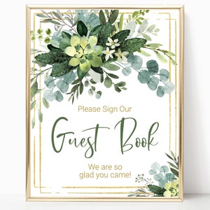 Könnte beinhalten: Ein druckbares Schild mit goldenem Rahmen und grünem Aquarell-Blumendesign. Das Schild lautet "Bitte unterschreiben Sie unser Gästebuch. Wir freuen uns, dass Sie gekommen sind!"