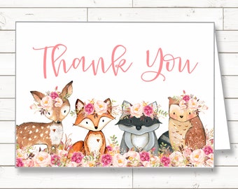 May include: Thank you card with a pink floral design featuring a deer, fox, raccoon, and owl wearing floral crowns.
