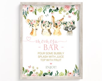 May include: A printable sign for a "momosa bar" with a floral border and illustrations of a deer, owl, rabbit, and raccoon wearing flower crowns. The text reads "momosa - BAR - POUR SOME BUBBLY SPLASH WITH JUICE TOP WITH FRUIT ENJOY!"
