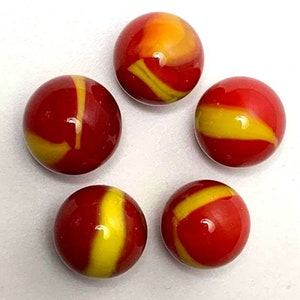 May include: Five red and yellow swirl glass marbles. The marbles have a red base with yellow swirls.