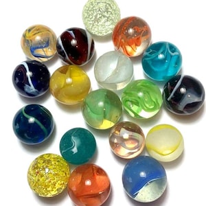May include: A collection of 18 colorful glass marbles in various patterns and colors, including blue, green, red, yellow, and white. The marbles are arranged in a random pattern on a white surface.