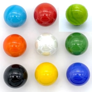 May include: Nine glass marbles in various colors, including blue, red, green, orange, white, yellow, and black. The marbles are arranged in three rows of three.