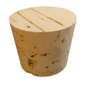 May include: A natural cork bottle stopper with a slightly tapered shape and a grooved top.