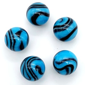 May include: Five blue glass marbles with black swirling patterns. The marbles are round and smooth.