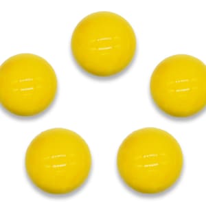 May include: Five bright yellow rubber balls with a textured surface.