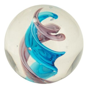 May include: A clear glass paperweight with a swirling design of blue and purple glass.