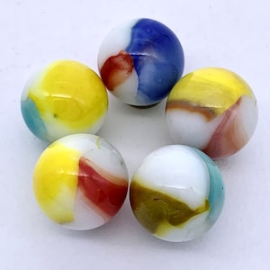 May include: Six colorful glass marbles with swirls of white, yellow, red, blue, and green. The marbles are arranged in a circle on a white surface.