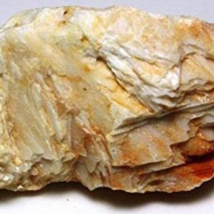 May include: A rough, white and orange rock with a layered, crystalline texture. The rock has a natural, earthy appearance.