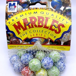 May include: A bag of 24 16mm glass marbles and one 25mm shooter marble. The marbles are white with colorful flecks and are packaged in a white mesh bag. The bag is labeled "Premium Quality Marbles The Collector Series 100% Pure Glass 24 16mm Players One 25mm Shooter".