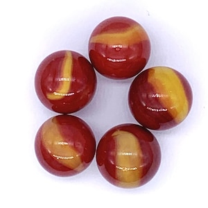 May include: Six red and yellow swirl glass marbles.