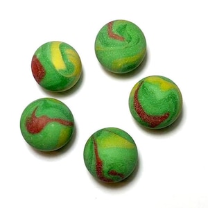 May include: Five green, red, and yellow swirl marbles. The marbles are about 1 inch in diameter.